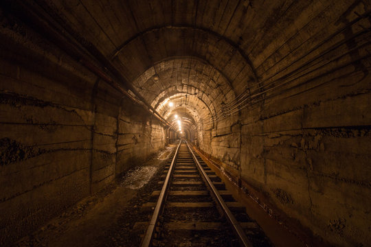 Fototapeta Gold iron mine ore shaft tunnel drift with rails underground