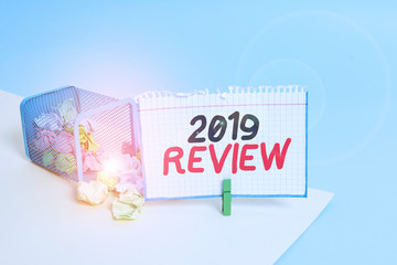 Word writing text 2019 Review. Business photo showcasing New trends and prospects in tourism or services for 2019 Trash bin crumpled paper clothespin empty reminder office supplies tipped