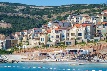 Fototapeta na wymiar Shore and beach of a seaside town, view from the sea