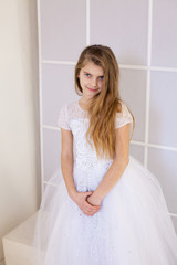 girl of twelve years in a beautiful white dress