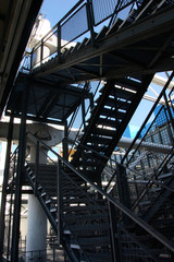 lots of metal stairways construction against blue sky background