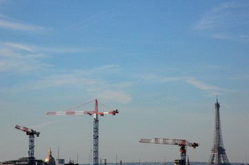 blue sky over Paris, cranes and Eiffel tower on the horizon