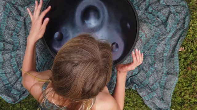 Beautiful female hands on a perfect musical percussion instrument.