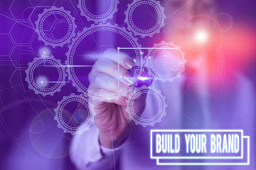 Writing note showing Build Your Brand. Business concept for enhancing brand equity using advertising campaigns Picture photo network scheme with modern smart device