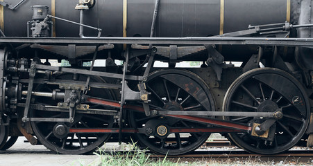 Fototapeta premium wheels of a steam locomotive stopped on a rail