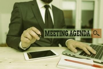 Conceptual hand writing showing Meeting Agenda. Concept meaning items that participants hope to accomplish at a meeting Male human wear formal clothes present use hitech smartphone