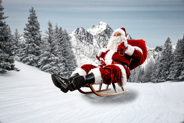 Red Santa Claus riding a wooden sled. An older man with a beard delivers presents to a child....