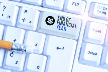 Conceptual hand writing showing End Of Financial Year. Concept meaning Revise and edit accounting sheets from previous year White pc keyboard with note paper above the white background