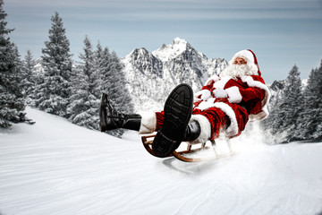 Red Santa Claus riding a wooden sled. An older man with a beard delivers presents to a child....