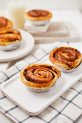 Fresh danish pastry with raisins on wood background.Tasty sweet bakery.