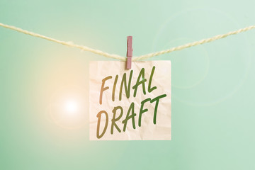 Text sign showing Final Draft. Business photo showcasing final version of something after a lot of editing and rewriting Clothesline clothespin rectangle shaped paper reminder white wood desk