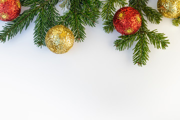 Christmas decorative background with tree branch, red bauble decorations, spruce on a white background