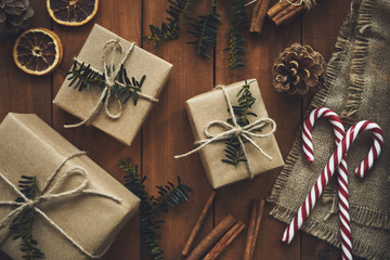 Christmas gifts on wooden table with decoration, top view