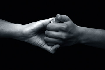 Isolated hands of male teenagers doing Ganesha Yoga Mudra with two hands-on black...