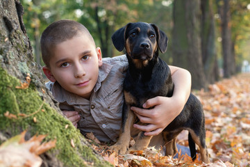 Happy smiling boy hugs his best friend  dog