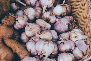 small market. sales of garlic. close-up, and shallow depth of field. there is tinting