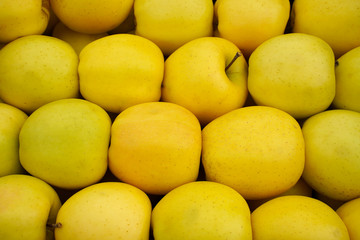 Fresh delicious apples in the store. Closeup.  They lie in boxes in front of the buyer. Healthy food. 