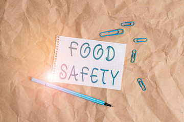 Writing note showing Food Safety. Business concept for conditions and practices that preserve the...
