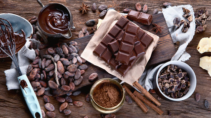 Cacao beans, powder, cacao butter,  chocolate bar and chocolate sauce - obrazy, fototapety, plakaty