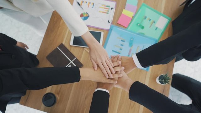 group of people stack hands put palms together.teamwork and unity concept business