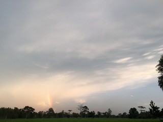 sunset and rainbow over the field and 