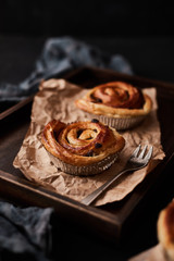 Fresh danish pastry with raisins on wood background.Tasty sweet bakery.