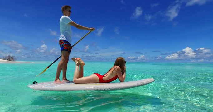 Happy Couple On Paddle Board, Honeymoon travel destination, Bali