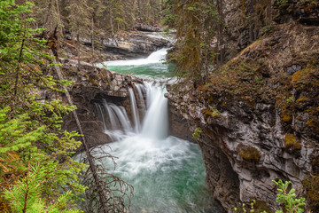 Fototapeta na wymiar Beautiful cascading waterfalls in Johnston Canyon in Banff, Canada