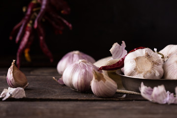 Organic Garlic bulb and garlic cloves on the wooden table in the garden.