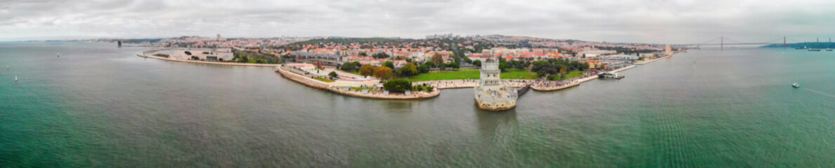 Obraz premium Amazing panoramic aerial view of Lisbon from drone. Belem Tower and city skyline at sunset