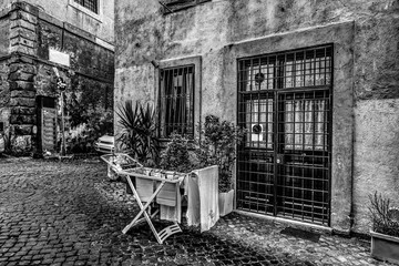 Fototapeta na wymiar Laundry rack in a rustic corner in Rome in black and white