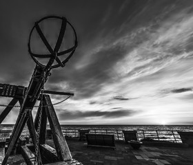 Antique catapult in Alghero seafront at sunset in black and white effect
