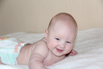 a small child lies on his tummy