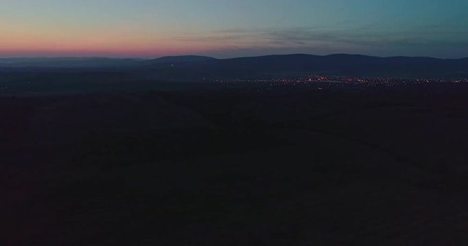 Autumn forest drone aerial shot at sunset. Overhead view of foliage trees in Hungary. Inspiring autumn season landscape panorama.