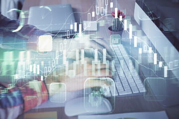 Double exposure of stock market chart with man working on computer on background. Concept of financial analysis.