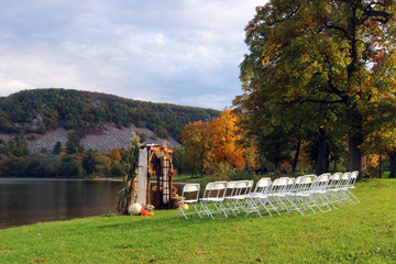 Wisconsin ice age nature background.Decorated wooden wedding arch and rows of white chairs prepared for wedding ceremony at the Devils Lake State Park south shore. Baraboo area, Wisconsin, Midwest USA