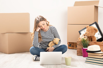 Young woman with boxes just moving into her new home