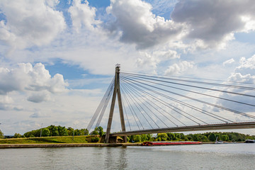 Stunning view of the cable-stayed Lanaye Bridge, which crosses the Albert Canal, a wonderful summer day with a blue sky, white and gray clouds in Belgium