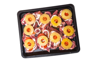 Homemade roasted meat with cheese and pineapples at baking tray, mayonnaise, cheese