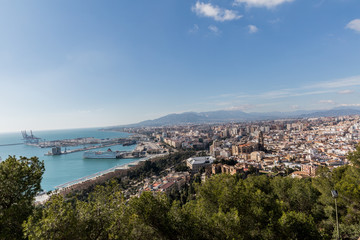 Obraz premium Port, sea, part of the city seen from the Alcazaba of Malaga, sunny day with a blue sky in the province of Malaga, Spain
