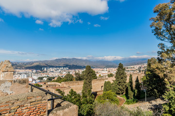 Part of the city of Malaga with mountains in the background seen from the Alcazaba, sunny day with a blue sky in the province of Malaga, Spain