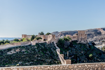 Fototapeta na wymiar Rocky hill with the walls and the Alcazaba in the background in Almeria Spain