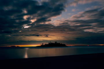 Fototapeta na wymiar island silhouette against the sunset sky