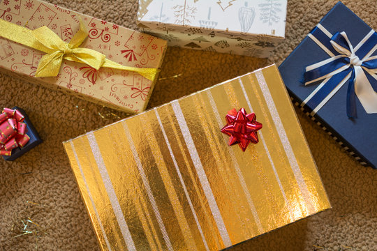 Gold And Blue Christmas Gift Boxes With Red Pompom.