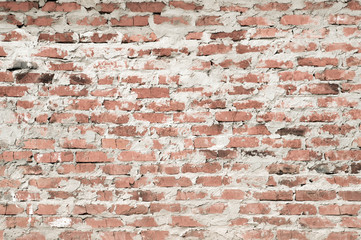 Red brick wall with rough cement mortar. Background