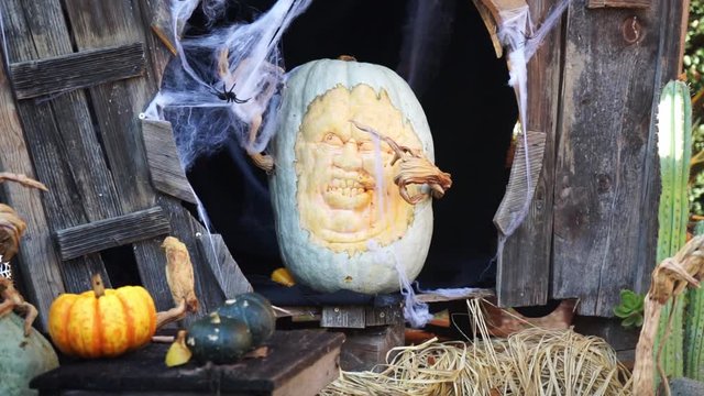Carved pumpkin figurine in a spooky house