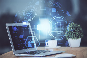 Computer on desktop with social network theme icon. Multi exposure. Concept of international connections.