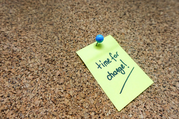 Yellow Sticky Note with Time For Change Message Pin on White Blue Push Pin On Cork board