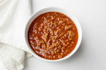 Top view of a bowl of red chili. Copy space. 