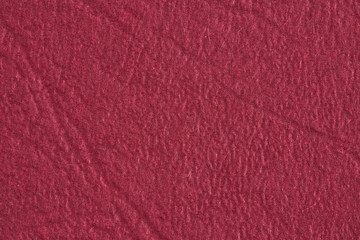 Burgundy paper with texture for background. Paper for interior and exterior decoration or background for handcrafts. Burgundy paper background.